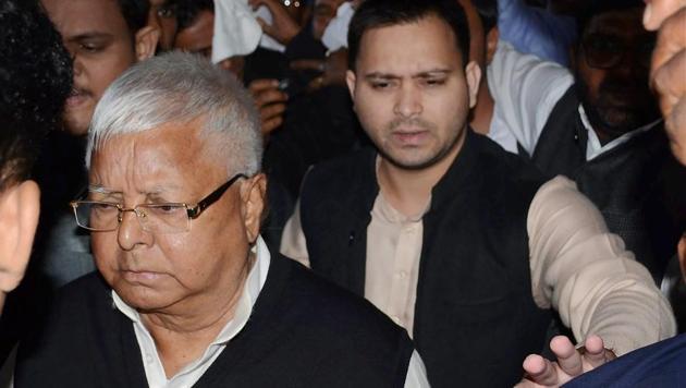 RJD chief Lalu Prasad and his son Tejashwi Yadav seen at Patna airport as he leaves for Ranchi on Friday. (PTI Photo) RJD chief Lalu Prasad and his son Tejashwi Yadav seen at Patna airport as he leaves for Ranchi on Friday. (PTI Photo)