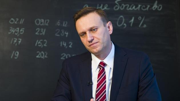 Russian opposition politician Alexei Navalny listens to a question during his interview to the Associated Press in Moscow, Russia. Russian opposition leader Alexei Navalny says he's confident he could beat Russian President Vladimir Putin in a fair election.(AP Photo)