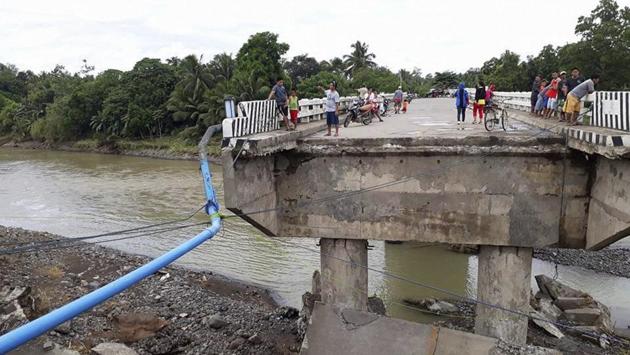 People gather on a bridge which was damaged by the onslaught of flooding brought by tropical storm Tembin on Sunday. Tembin struck less than a week after Tropical Storm Kai-Tak left scores dead and more than 20 missing in central Philippines, straining the nation’s already stretched resources. The storm swept into the South China Sea before dawn Sunday. (AP) People gather on a bridge which was damaged by the onslaught of flooding brought by tropical storm Tembin on Sunday. Tembin struck less than a week after Tropical Storm Kai-Tak left scores dead and more than 20 missing in central Philippines, straining the nation’s already stretched resources. The storm swept into the South China Sea before dawn Sunday. (AP)