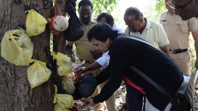 Maharashtra Andhashraddha Nirmulan Samiti members destroy black magic material fixed on trees near Holkar bridge on Saturday. (HT PHOTO) Maharashtra Andhashraddha Nirmulan Samiti members destroy black magic material fixed on trees near Holkar bridge on Saturday. (HT PHOTO)