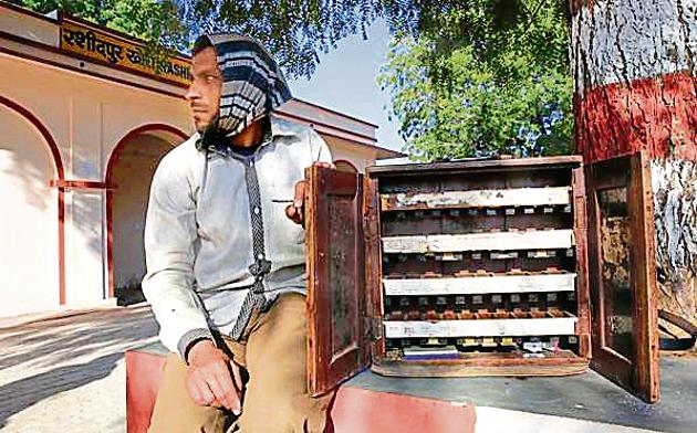 Mahendra Kumar uses a portable chest to sell tickets at the Rashidpur Khori railway station in Rajasthan.(Himanshu Vyas/HT Photo)