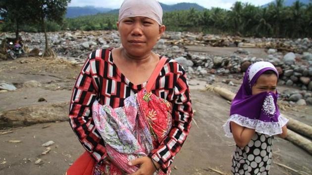 Residents weep in a village devastated by flash floods in Lanao del Norte, Philippines. The archipelago nation is battered by about 20 typhoons a year. Mindanao tends to be less affected and officials said this may have caused many to ignore warnings to move to safer ground. (Richel V. Umel / REUTERS) Residents weep in a village devastated by flash floods in Lanao del Norte, Philippines. The archipelago nation is battered by about 20 typhoons a year. Mindanao tends to be less affected and officials said this may have caused many to ignore warnings to move to safer ground. (Richel V. Umel / REUTERS)