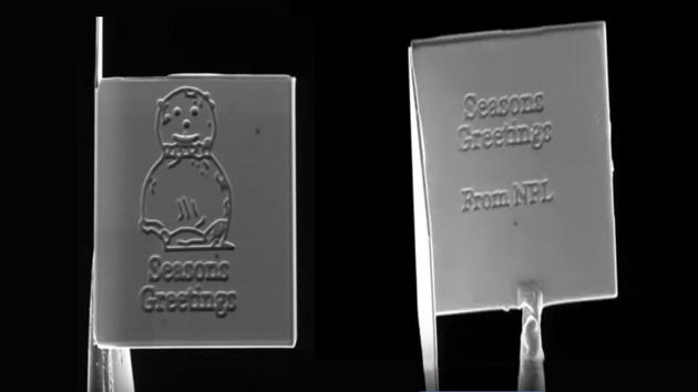 Scientists have created the world’s smallest Christmas card - measuring just 15 micrometres wide - that could fit over 200 million cards in a single postage stamp. (Screengrabs from YoutUbe video posted by National Physical Laboratory) Scientists have created the world’s smallest Christmas card - measuring just 15 micrometres wide - that could fit over 200 million cards in a single postage stamp. (Screengrabs from YoutUbe video posted by National Physical Laboratory)