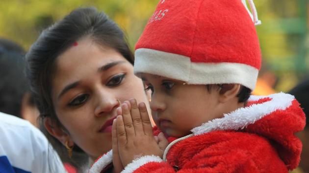 A child offers prayers at a church in Chandigarh on the eve of Christmas celebrations. (Karun Sharma/HT) 