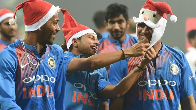Mahendra Singh Dhoni (R) wears a Santa Claus cap as teammates Kuldeep Yadav (C) and Hardik Pandya (L) look on. (AFP) Mahendra Singh Dhoni (R) wears a Santa Claus cap as teammates Kuldeep Yadav (C) and Hardik Pandya (L) look on. (AFP)
