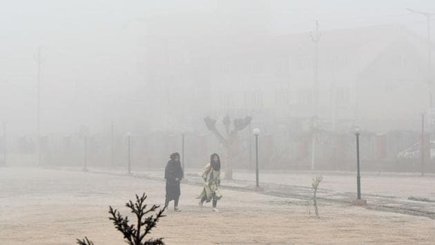 Girls walks in a park on a cold and foggy morning in Srinagar on Monday. (AFP Photo) Girls walks in a park on a cold and foggy morning in Srinagar on Monday. (AFP Photo)