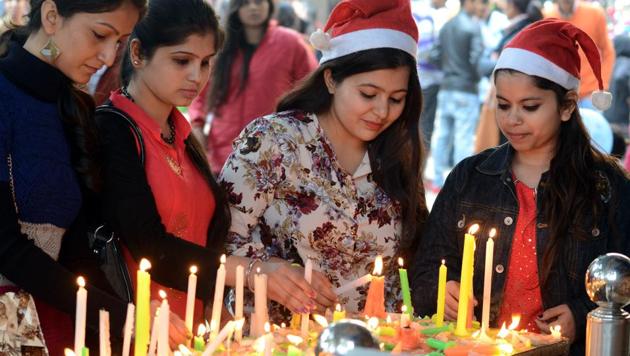 Women light candles as they celebrate Christmas at the Sacred Heart Catholic Church in Jalandhar. (Pardeep Pandit/HT ) Women light candles as they celebrate Christmas at the Sacred Heart Catholic Church in Jalandhar. (Pardeep Pandit/HT )