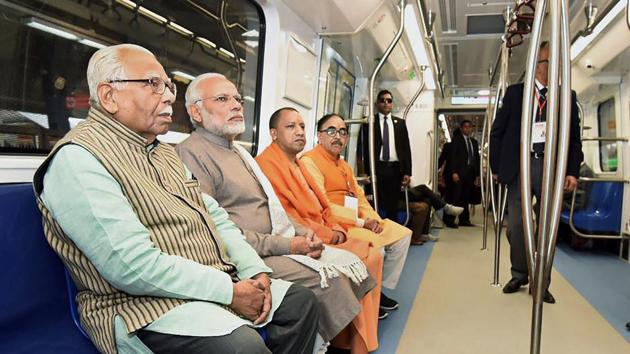Prime Minister Narendra Modi takes a ride on a Metro train from Botanical Garden Station to Okhla Bird Sanctuary along with Uttar Pradesh governor Ram Naik and Uttar Pradesh CM Yogi Adityanath on Monday. (PTI) Prime Minister Narendra Modi takes a ride on a Metro train from Botanical Garden Station to Okhla Bird Sanctuary along with Uttar Pradesh governor Ram Naik and Uttar Pradesh CM Yogi Adityanath on Monday. (PTI)