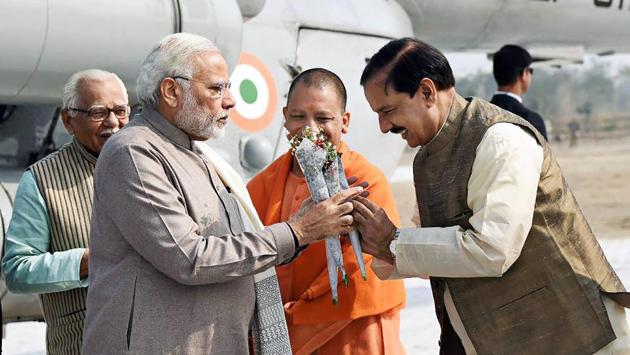 Prime Minister Narendra Modi is greeted by Minister of State for Culture (I/C) and Environment, Forest & Climate Change, Mahesh Sharma with Governor of Uttar Pradesh, Ram Naik, Chief Minister, Uttar Pradesh, Yogi Adityanath (back), on his arrival at Botanical Garden, in Noida, Uttar Pradesh. (PIB / PTI) Prime Minister Narendra Modi is greeted by Minister of State for Culture (I/C) and Environment, Forest & Climate Change, Mahesh Sharma with Governor of Uttar Pradesh, Ram Naik, Chief Minister, Uttar Pradesh, Yogi Adityanath (back), on his arrival at Botanical Garden, in Noida, Uttar Pradesh. (PIB / PTI)