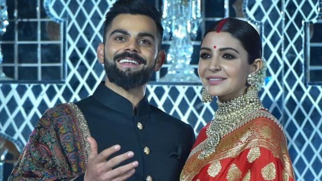 Indian cricket captain Virat Kohli and his actress wife Anushka Sharma pose for photographers during their wedding reception in New Delhi on December 21, 2017. Kohli skipped the ODI and T20 series against Sri Lanka.(PTI)