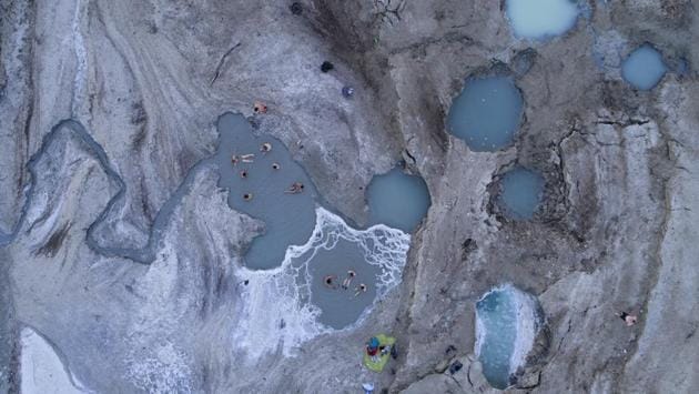 An aerial view shows visitors in a spring water pool on the Dead Sea shore. Israeli and Jordanian industries extracting minerals and salts from the salty lake are responsible for the other 40% of losses to the water level. (Oded Balilty / AP) An aerial view shows visitors in a spring water pool on the Dead Sea shore. Israeli and Jordanian industries extracting minerals and salts from the salty lake are responsible for the other 40% of losses to the water level. (Oded Balilty / AP)