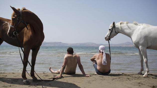 Israeli Druse men sit with their horses on the shores of the Sea of Galilee near Ein Gev. Gidon Bromberg, director of EcoPeace says Israel, Jordan and the Palestinians are all responsible for the dire state of the Jordan. Instead of fresh water keeping the lower Jordan alive, it is filled with sewage and waste. “That’s actually what’s kept the river wet — a combination of agricultural runoff, sewage water and saline waters,” he said. (Oded Balilty / AP) Israeli Druse men sit with their horses on the shores of the Sea of Galilee near Ein Gev. Gidon Bromberg, director of EcoPeace says Israel, Jordan and the Palestinians are all responsible for the dire state of the Jordan. Instead of fresh water keeping the lower Jordan alive, it is filled with sewage and waste. “That’s actually what’s kept the river wet — a combination of agricultural runoff, sewage water and saline waters,” he said. (Oded Balilty / AP)