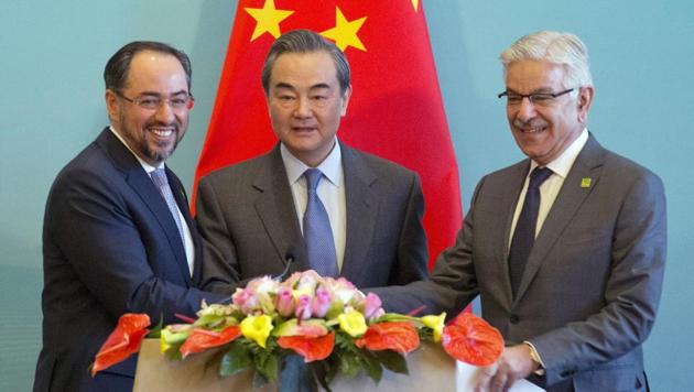 (From left) Afghanistan foreign minister Salahuddin Rabbani, Chinese foreign minister Wang Yi and Pakistani foreign minister Khawaja Asif hold hands to pose for a photo after a press conference for the 1st China-Afghanistan-Pakistan Foreign Ministers' Dialogue held in Beijing, China. (AP) (From left) Afghanistan foreign minister Salahuddin Rabbani, Chinese foreign minister Wang Yi and Pakistani foreign minister Khawaja Asif hold hands to pose for a photo after a press conference for the 1st China-Afghanistan-Pakistan Foreign Ministers' Dialogue held in Beijing, China. (AP)