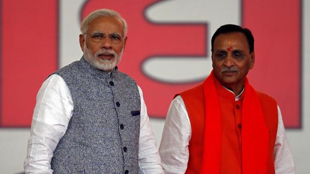 Vijay Rupani (right) with Prime Minister Narendra Modi after taking his oath as the chief minister of Gujarat during a swearing-in ceremony at Gandhinagar, on December 26, 2017.(Reuters)