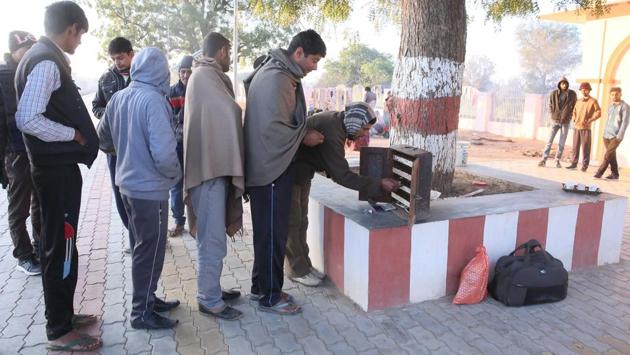 Passengers are seen collecting tickets from Kumar to travel. (Himanshu Vyas / HT Photo)