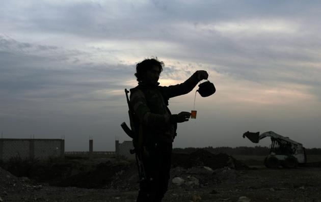 A Free Syrian Army fighter pours tea in the rebel-held town of Dael on December 22, 2017. (Reuters) A Free Syrian Army fighter pours tea in the rebel-held town of Dael on December 22, 2017. (Reuters)