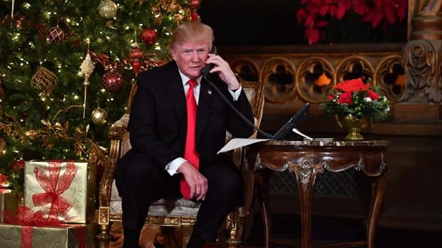 US President Donald Trump participates in NORAD Santa Tracker phone calls at the Mar-a-Lago resort in Palm Beach, Florida, on December 24, 2017. "NORAD Tracks Santa" is an annual Christmas-themed entertainment programme, which has existed since 1955, produced under the auspices of the North American Aerospace Defense Command. (AFP) US President Donald Trump participates in NORAD Santa Tracker phone calls at the Mar-a-Lago resort in Palm Beach, Florida, on December 24, 2017. "NORAD Tracks Santa" is an annual Christmas-themed entertainment programme, which has existed since 1955, produced under the auspices of the North American Aerospace Defense Command. (AFP)