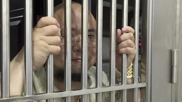 In this May 19, 2015 photo, Wu Gan also known as the Ultra Vulgar Butcher is seen behind bars at police station in Nanchang city in eastern China's Jiangxi province. (AP File Photo) In this May 19, 2015 photo, Wu Gan also known as the Ultra Vulgar Butcher is seen behind bars at police station in Nanchang city in eastern China's Jiangxi province. (AP File Photo)