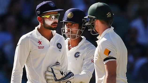 Virat Kohli is held back by keeper Wriddhiman Saha as he has words with Steve Smith day four of the first Test match between Australia and India at Adelaide Oval on December 12, 2014. Rohit Sharma feels marriage with Anushka Sharma could mellow down the Indian cricket captain.(Getty Images)