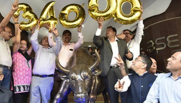 Stock marketers celebrate after the Sensex reached 34000 outside the Bombay Stock Exchange in Mumbai on Tuesday (Anshuman Poyrekar/HT Photo) Stock marketers celebrate after the Sensex reached 34000 outside the Bombay Stock Exchange in Mumbai on Tuesday (Anshuman Poyrekar/HT Photo)