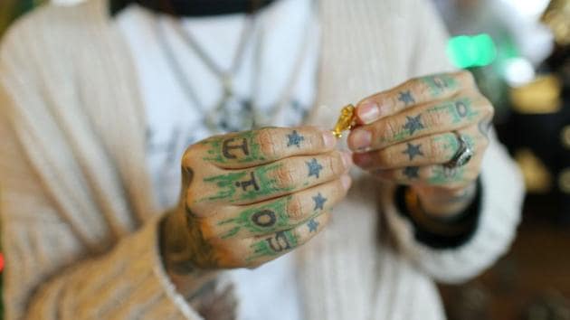 Tattoos displayed on the fingers of Zhuo Danting, widely considered one of China’s top tattoo artists at her studio. The 35-year-old has 70% of her body tattooed and has witnessed first-hand the tattoo explosion, having run her own Shanghai studio for 11 years. (AFP)