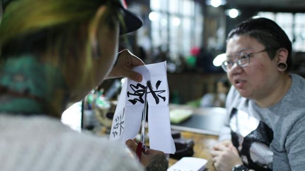 Zhuo (L) prepares a design for web designer and tattoo enthusiast Wang Qi (R) at her studio. 29-year-old Wang has several body designs. Her latest: Chinese characters for her grandmother’s name on the inside of her thigh. “Ten years ago, only 10% of people could accept women doing this. But now at least 60 to 70% of people can,” Wang said, while adding that quality can vary widely. (AFP)