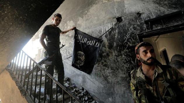 A member of the Syrian Democratic Forces calls his comrades during the fighting with Islamic State fighters in Raqqa, Syria. (REUTERS FILE) A member of the Syrian Democratic Forces calls his comrades during the fighting with Islamic State fighters in Raqqa, Syria. (REUTERS FILE)