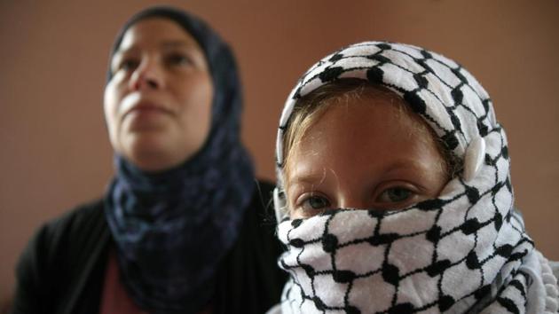 Nariman Tamimi (L) and her daughter Ahed get ready for a weekly demonstration against Israeli occupation in Nabi Saleh on August 31, 2012. As Palestinians continue protests against Donald Trump’s decision to recognize Jerusalem as Israel’s capital, the image of the teenage girl facing the Israeli army has captured imaginations, breaking the narrative of an intifada symbolized by tear gas canisters and rock pelting. (Abbas Momani / AFP File) Nariman Tamimi (L) and her daughter Ahed get ready for a weekly demonstration against Israeli occupation in Nabi Saleh on August 31, 2012. As Palestinians continue protests against Donald Trump’s decision to recognize Jerusalem as Israel’s capital, the image of the teenage girl facing the Israeli army has captured imaginations, breaking the narrative of an intifada symbolized by tear gas canisters and rock pelting. (Abbas Momani / AFP File)