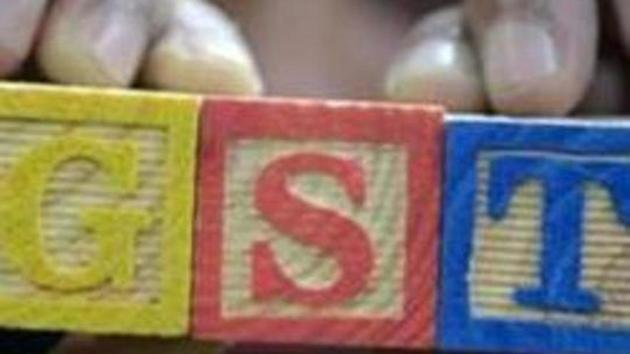 A consumer goods trader shows letters GST representing "Goods and Services Tax" (GST) at his shop in Hyderabad. (AFP FILE) A consumer goods trader shows letters GST representing "Goods and Services Tax" (GST) at his shop in Hyderabad. (AFP FILE)