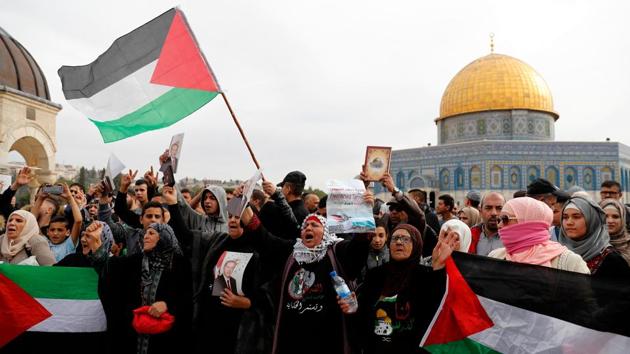 People hold a portrait of Turkish President Recep Tayyip Erdogan and a poster calling for Ahed Tamimi’s release after Friday prayers at al-Aqsa mosque on December 22, 2017. On the Palestinian front her actions garnered outright praise but also questioned whether the video might have damaged their cause, by showing Israelis behaving gently, or aided it, by showing that even unarmed resistance can be effective. (Ahmad Gharabli / AFP) People hold a portrait of Turkish President Recep Tayyip Erdogan and a poster calling for Ahed Tamimi’s release after Friday prayers at al-Aqsa mosque on December 22, 2017. On the Palestinian front her actions garnered outright praise but also questioned whether the video might have damaged their cause, by showing Israelis behaving gently, or aided it, by showing that even unarmed resistance can be effective. (Ahmad Gharabli / AFP)