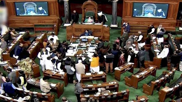 Opposition members protest in the well of the Lok Sabha in New Delhi on Wednesday during the ongoing winter session of Parliament. (PTI) Opposition members protest in the well of the Lok Sabha in New Delhi on Wednesday during the ongoing winter session of Parliament. (PTI)