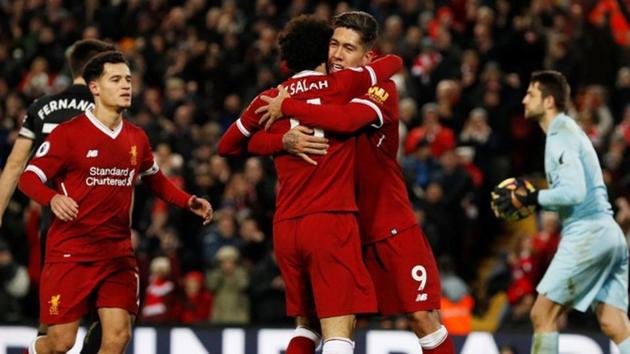 Roberto Firmino celebrates scoring one of his two goals against Swansea City in the Premier League on Tuesday. (REUTERS) Roberto Firmino celebrates scoring one of his two goals against Swansea City in the Premier League on Tuesday. (REUTERS)
