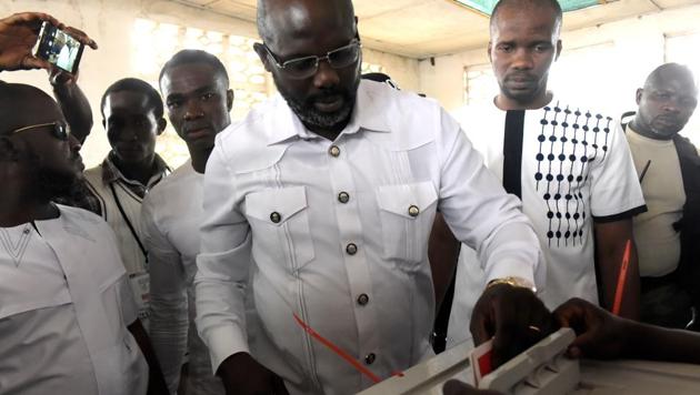 Football icon and candidate for the president election for the Coalition for Democratic Change (CDC), George Weah casts his ballot for the second round of presidential elections on December 26, 2017 at a polling station in Monrovia. (AFP) Football icon and candidate for the president election for the Coalition for Democratic Change (CDC), George Weah casts his ballot for the second round of presidential elections on December 26, 2017 at a polling station in Monrovia. (AFP)