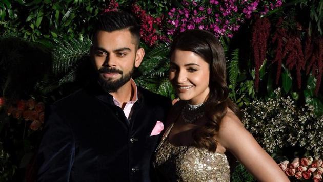 Indian cricket team captain Virat Kohli and his actress wife Anushka Sharma pose for photographers during their wedding reception in Mumbai on Tuesday. The Indian team leaves for South Africa on Wednesday night.(PTI)