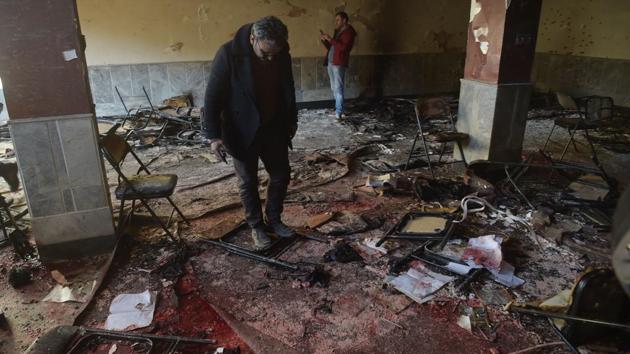 Afghan residents inspect the site of a bomb attack at a Shiite cultural centre in Kabul on December 28, 2017. The IS-linked Aamaq news agency said three bombs were used in the assault as well as a single suicide bomber who blew himself up inside the center, where scores had gathered to mark the 1979 invasion of Afghanistan by the former Soviet Union. (Shah Marai / AFP)