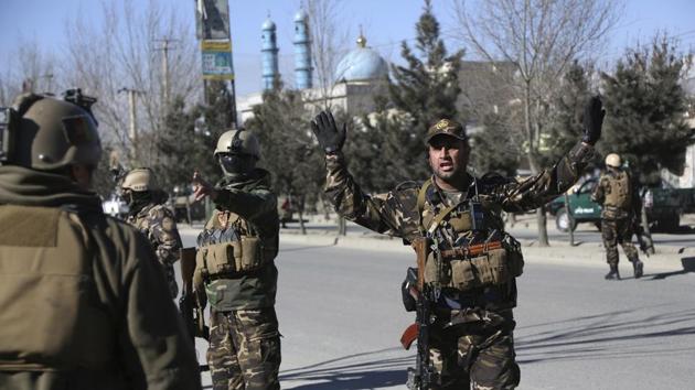 Afghan policemen stand guard at the site of a blast in Kabul. By late afternoon Wahid Mujro, spokesman for the public health ministry, said 41 were dead and 84 others were wounded in the blasts on an office of the Afghan Voice news agency and a neighbouring cultural centre. (Rahmat Gul / AP)