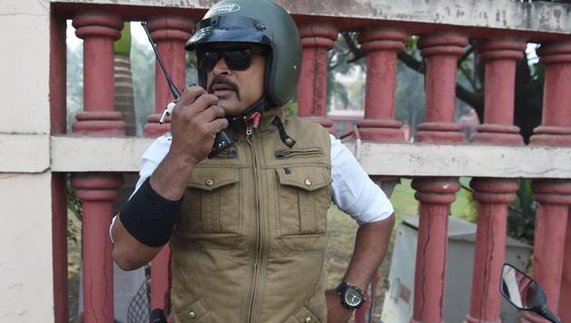 Ranjeet Singh speaks into a handset while working at an intersection in Indore. He has become a social media phenomenon with nearly 50,000 people following his activities on Facebook. (Indranil Mukherjee / AFP)