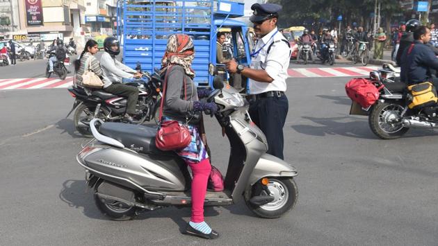 Singh cautions a motorist. He claims the number of traffic violations at the High Court intersection where he spends most days has fallen over the years. A university is studying his methods to see whether he has cut traffic jams as well. (Indranil Mukherjee / AFP)