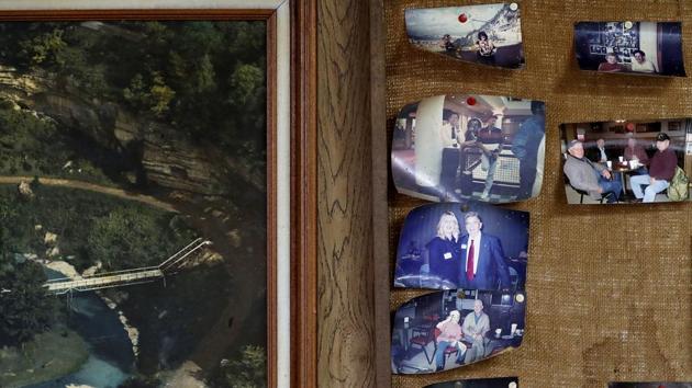 Photos curled at the edges decorate a board in the restaurant. The national news and ceaseless Twitter taunts scroll across the diner’s TV, rarely registering. Allegiance here means God, guns, patriotism, saying “Merry Christmas” and not Happy Holidays. It means validation against gay marriage, immigration and factories moving overseas. And tearing down a political system that neglected them in favour of big cities. On those counts, they believe Trump delivered. (David Goldman / AP) Photos curled at the edges decorate a board in the restaurant. The national news and ceaseless Twitter taunts scroll across the diner’s TV, rarely registering. Allegiance here means God, guns, patriotism, saying “Merry Christmas” and not Happy Holidays. It means validation against gay marriage, immigration and factories moving overseas. And tearing down a political system that neglected them in favour of big cities. On those counts, they believe Trump delivered. (David Goldman / AP)