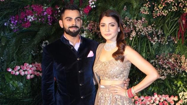 Anushka in a breathtaking vintage-feeling lehenga set by her go-to designer, Sabyasachi Mukherjee, and Virat in a dapper bandhgala suit by Raghavendra Rathore at their wedding reception in Mumbai on Tuesday.(IANS)
