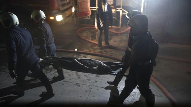 An injured person being rushed to the hospital. The fire started after 12:30am on the third floor of the building on Senapati Bapat Marg, a commercial hub of the city, a police official said. (ANSHUMAN POYREKAR/HT PHOTO)