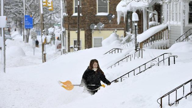 Rochelle Carlotti, 28, shovels steps near her home after a record snowfall on December 26, 2017 in Erie, Pennsylvania. The National Weather Service office in Cleveland says Monday's storm brought 34 inches of snow, an all-time daily snowfall record for Erie as a cold wave sweeps North America. (Greg Wohlford / Erie Times-News via AP) Rochelle Carlotti, 28, shovels steps near her home after a record snowfall on December 26, 2017 in Erie, Pennsylvania. The National Weather Service office in Cleveland says Monday's storm brought 34 inches of snow, an all-time daily snowfall record for Erie as a cold wave sweeps North America. (Greg Wohlford / Erie Times-News via AP)