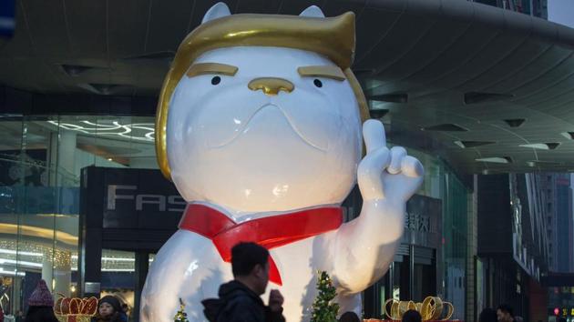 People walk past a statue of a dog, with a resemblance to US President Donald Trump, outside a shopping mall in Taiyuan, in China's northern Shanxi province on December 29, 2017. (AFP) People walk past a statue of a dog, with a resemblance to US President Donald Trump, outside a shopping mall in Taiyuan, in China's northern Shanxi province on December 29, 2017. (AFP)