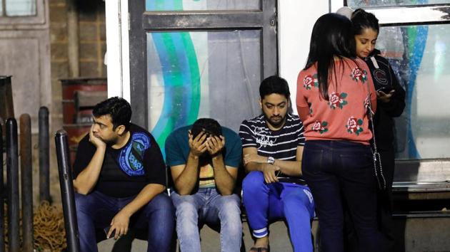 Friends of a victim killed in a fire at a restaurant wait at a hospital in Mumbai. (REUTERS) Friends of a victim killed in a fire at a restaurant wait at a hospital in Mumbai. (REUTERS)
