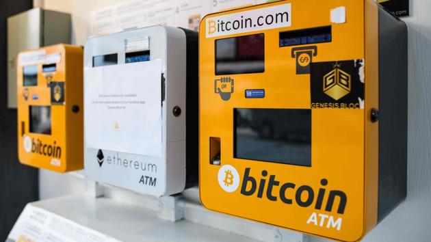 ATM machines (L and R) for digital currency Bitcoin are seen in Hong Kong on December 18, 2017. Bitcoins’ market price is almost certain at some point to crash and burn, just as the dot-coms did.(AFP Photo)