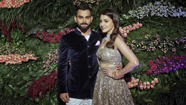 Indian cricketer Virat Kohli (L) and Bollywood actress Anushka Sharma, pose during their wedding reception in Mumbai on December 26, 2017. (Rajanish Kakade / AP)