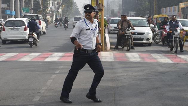 Traffic policeman Ranjeet Singh directs traffic while ‘moonwalking’ at an intersection in Indore. (Indranil Mukherjee / AFP)