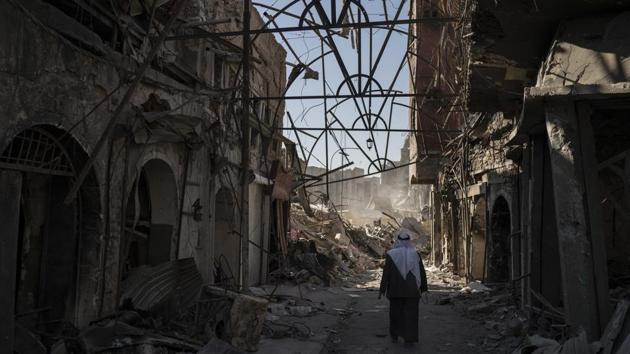 A man walks between destroyed shops in the Old City of Mosul. The longer it takes, the longer those who fled the fighting remain uprooted. While 2.7 million Iraqis have returned, more than 3 million others cannot and languish in camps. Worst hit is Mosul; the UN estimates 40,000 homes there need to be rebuilt, and some 600,000 of its once 2 million residents have been unable to return. (Felipe Dana / AP) A man walks between destroyed shops in the Old City of Mosul. The longer it takes, the longer those who fled the fighting remain uprooted. While 2.7 million Iraqis have returned, more than 3 million others cannot and languish in camps. Worst hit is Mosul; the UN estimates 40,000 homes there need to be rebuilt, and some 600,000 of its once 2 million residents have been unable to return. (Felipe Dana / AP)