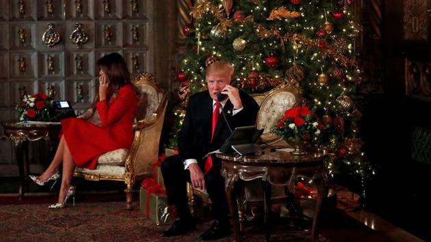 US President Donald Trump and First Lady Melania Trump attend to NORAD (North American Aerospace Defense Command) Santa Tracker phone calls with children at Mar-a-Lago estate in Palm Beach, Florida on December 24, 2017. (Carlos Barria / REUTERS) US President Donald Trump and First Lady Melania Trump attend to NORAD (North American Aerospace Defense Command) Santa Tracker phone calls with children at Mar-a-Lago estate in Palm Beach, Florida on December 24, 2017. (Carlos Barria / REUTERS)