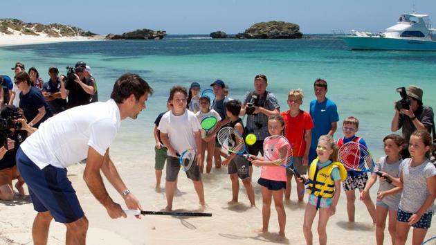 Roger Federer gives local children a tennis lesson on a beach at Rottnest Island off the coast of Western Australia. (AFP)